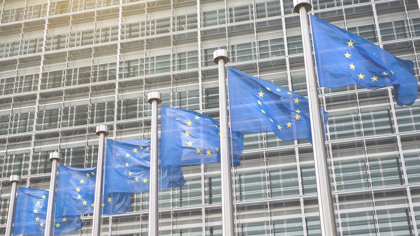 6 EU flags waving in front of a building