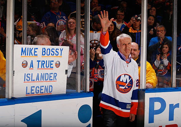 Former New York Islandes Mike Bossy waves to the crowd prior to the game duing Mike Bossy tribute Night at the Nassau Veterans Memorial Coliseum on...