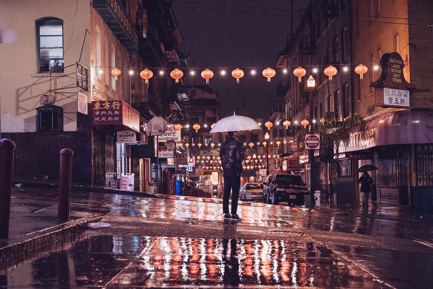 photo of man w/umbrella in Chinatown