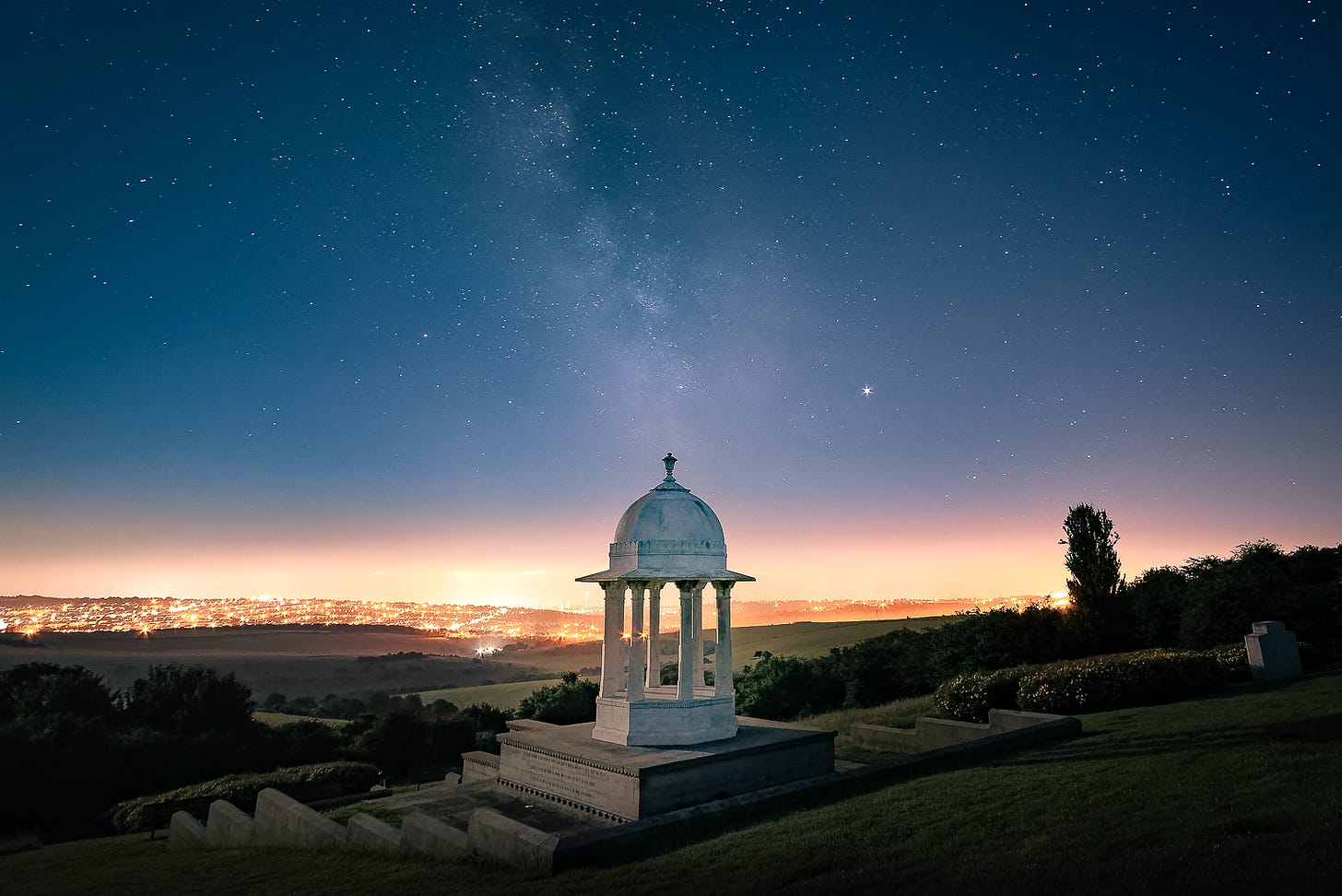 The Chattri, a memorial to the Indian soldiers who fought during First World War. The Milky Way and Jupiter are visible in the sky.