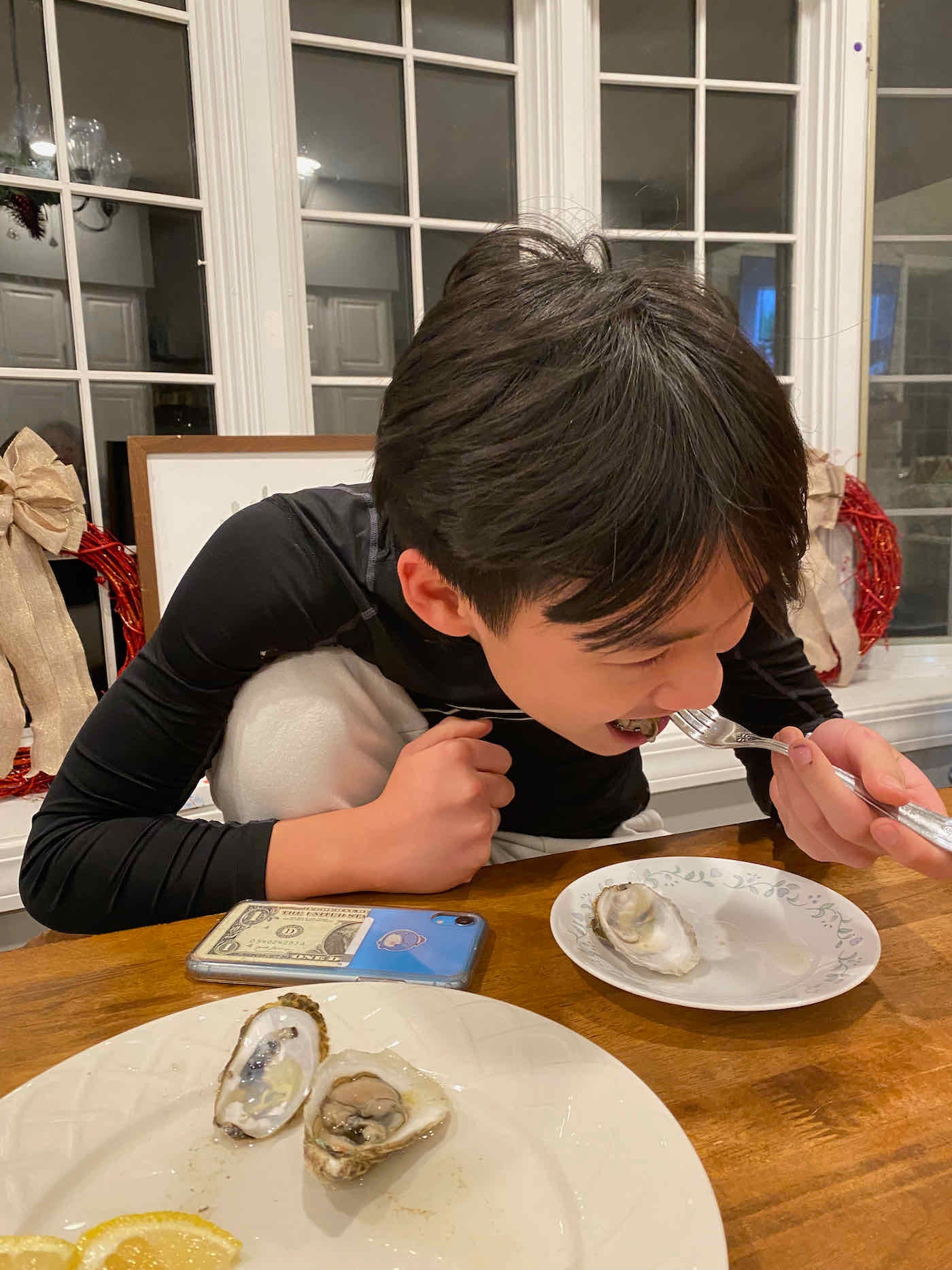 13-year-old Caleb tastes his first-ever raw oyster