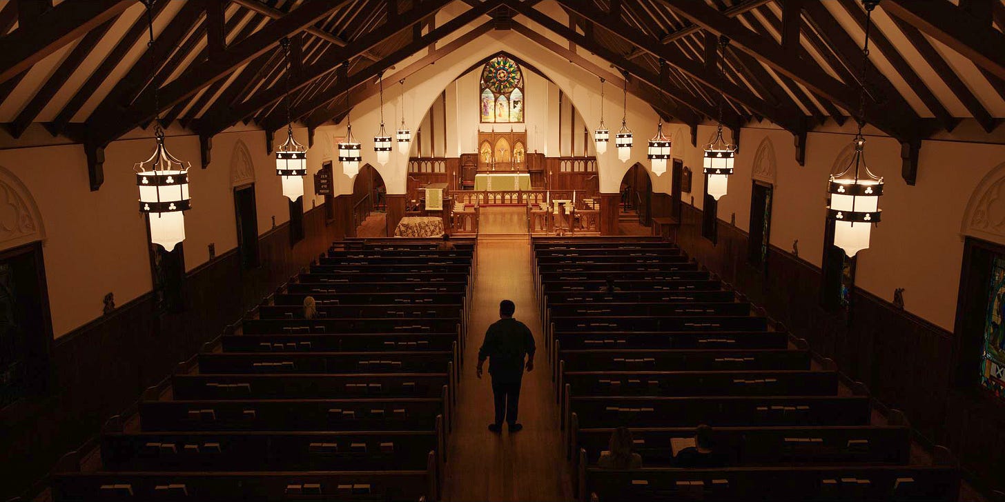 A man stands in the nave of a church