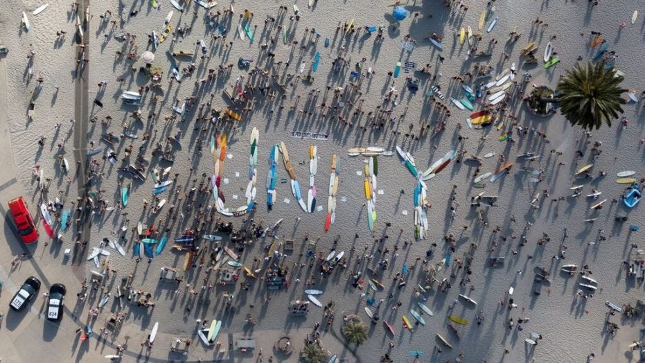 California surfers spell out 'unity' with boards before staging ...