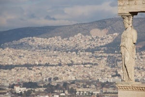 Hills of Athens seen behind Erechtheion caryatid.jpg