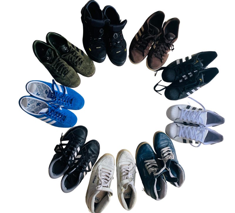 Nine Adidas trainers arranged in a circle.