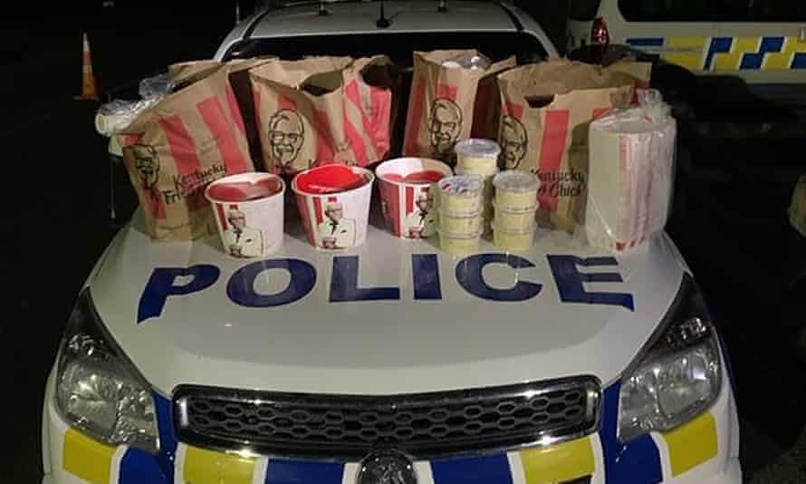 The hood of a New Zealand police car with what appears to be a regular family size order of KFC spread out on it like it was the biggest drug bust in the country’s history.
