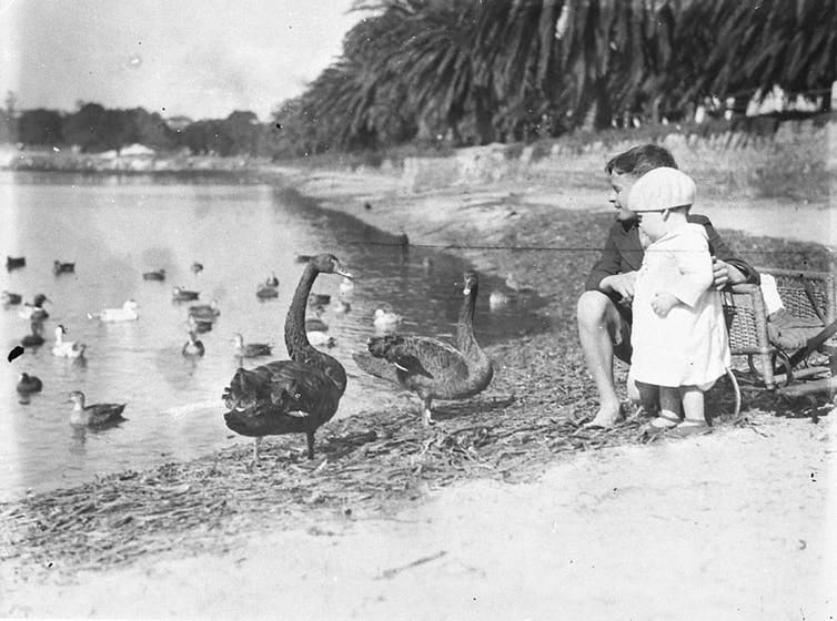 black and white photo of kids at lake with birds