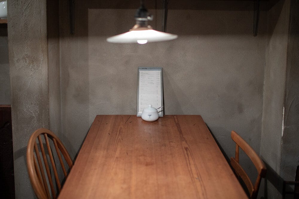 A simple aesthetic at Elephant Factory: wooden tables and chairs, a one page menu, and bare-bones walls.