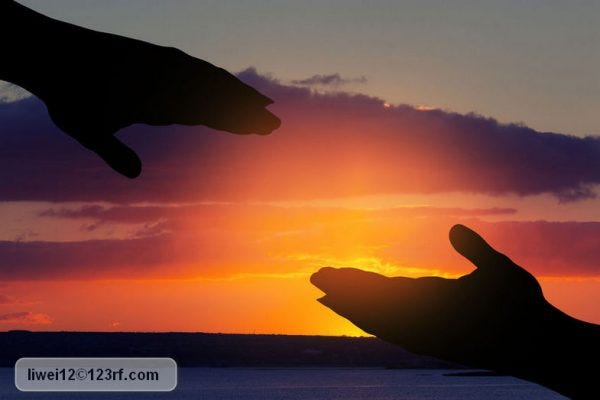 silhouette of helping hand on sky background;