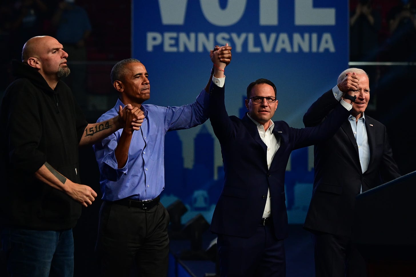 Democratic candidate for U.S. Senator John Fetterman, former President Barack Obama, Democratic candidate for Governor Josh Shapiro, and President Joe Biden raise their arms when departing after a rally at the Liacouras Center on November 5, 2022 in Philadelphia, Pennsylvania. (Photo by Mark Makela/Getty Images)