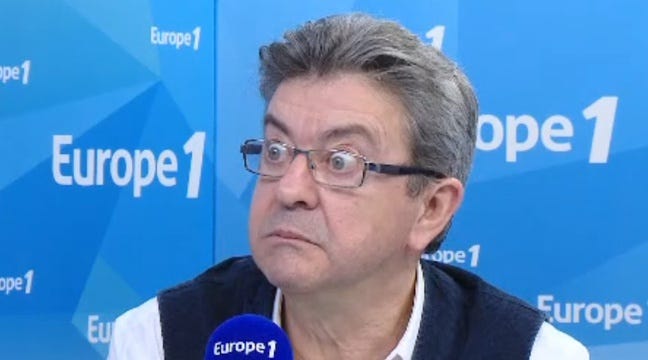 Jean-Luc Mélenchon with a wide-eyed, shocked expression during a 2017 Europe 1 interview