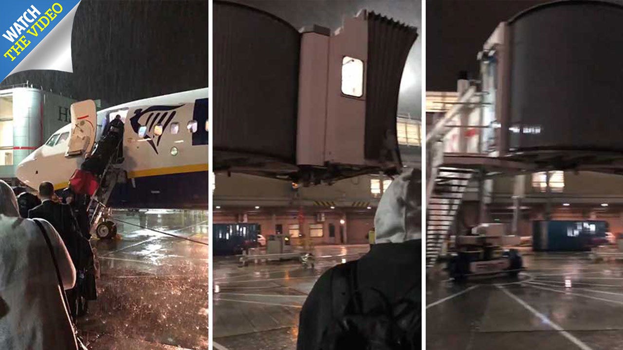Furious Ryanair passengers forced to queue in torrential rain to ...