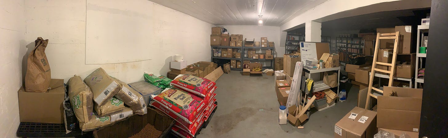 wide shot of basement room with boxes stacked on shelves