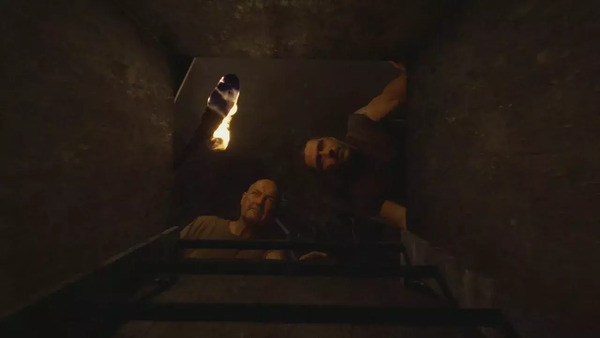 John Locke "Terry O'Quinn) and Jack Shephard (Matthew Fox) peer down the shaft of the now-open hatch.