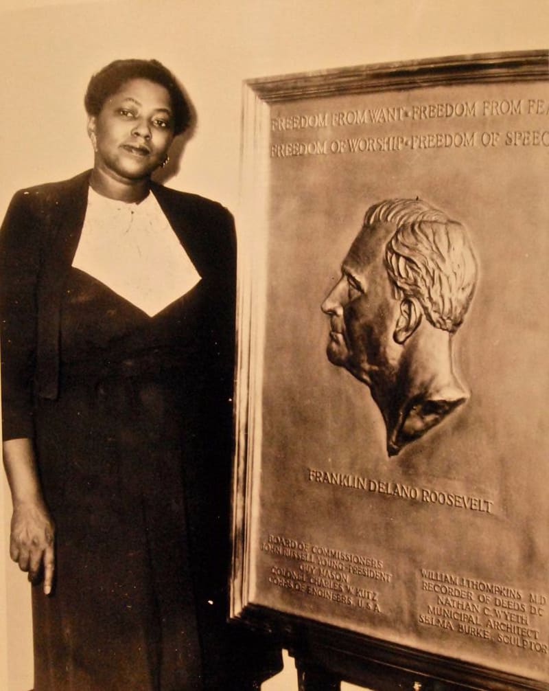 Selma Burke poses with a bronze plaque of the late U.S. President Franklin D. Roosevelt, which she completed shortly after his death on April 12, 1945. The plaque, showing the late president’s profile, with the four freedoms (freedom from want, freedom from fear, freedom of worship and freedom of speech) above it, was approved by the president’s widow. CONTRIBUTED BY OFFICE OF WAR INFORMATION COLLECTION, NATIONAL MUSEUM OF THE U.S. NAVY