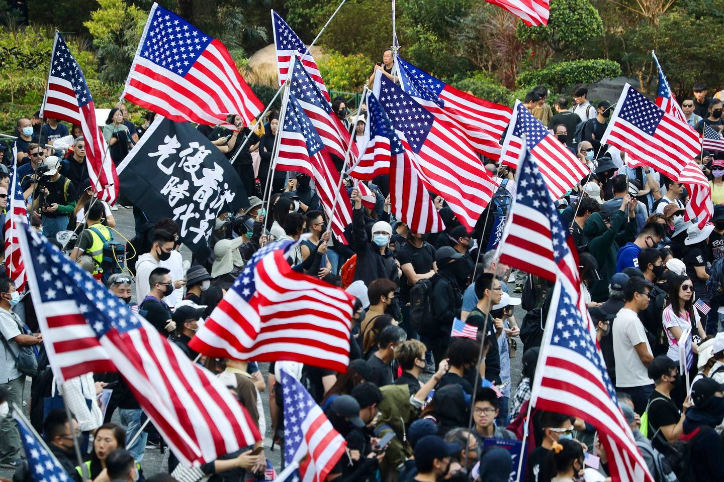 Protesters wave American flags during a rally outside the US Consulate in Hong Kong in December.