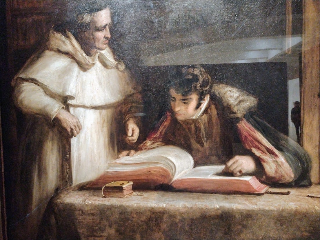 Young man poring over large book under supervision of a Franciscan Friar
