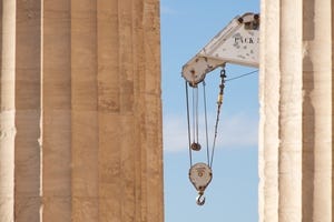 White crane between two marble Parthenon columns.jpg
