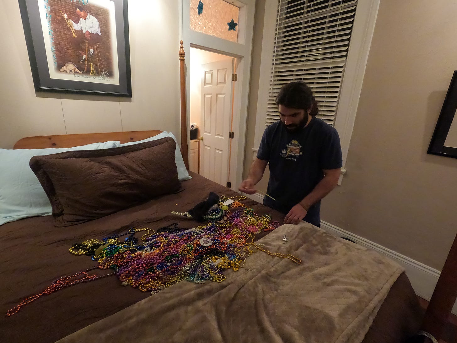 anthony looks down at the bed covered in hundred of colorful beads