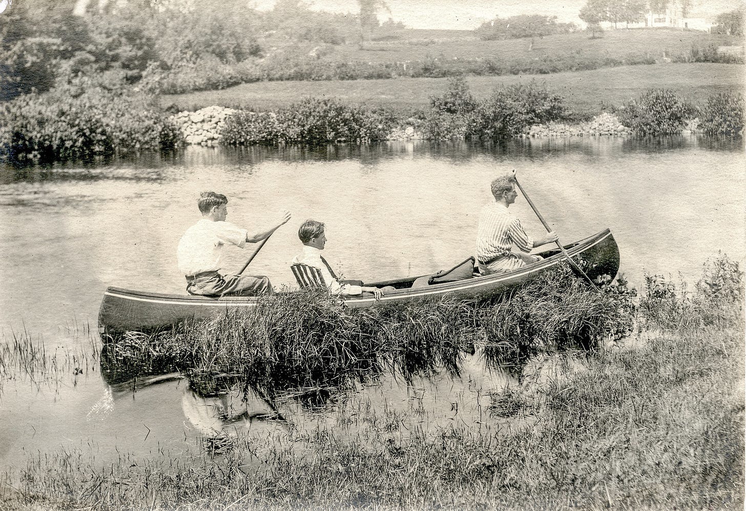 3 men in canoe