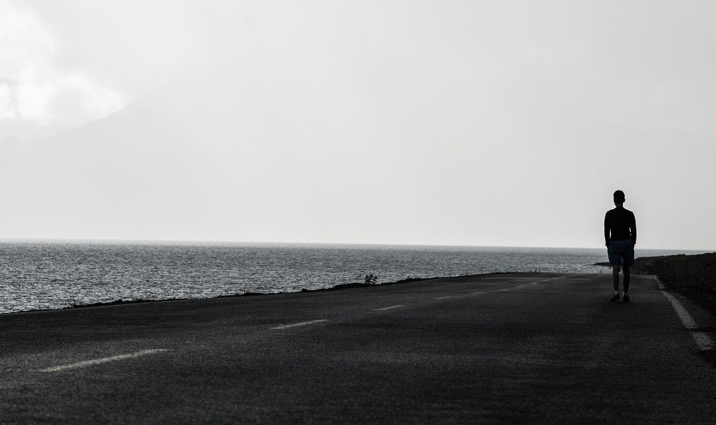 silhouette of a man walking on the road alone for article by Larry G. Maguire