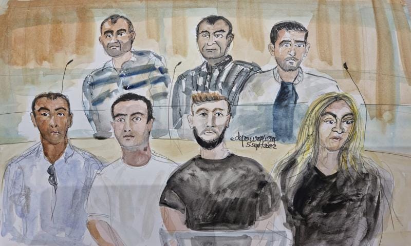 In this courtroom sketch by Elisabeth de Pourquery, suspects from the left, rear, Artan Henaj, Chakri Chafroud, Ramzi Arefa, and below, Mohamed Walid Ghraieb, Endri Elezi, Makzim Celaj and Enkeledka Zace sit in court on the first day of the Nice attack trial in Paris, Monday, Sept. 5, 2022. A special French terrorism court on Monday opened the trial of eight people accused of helping a man who, on Bastille Day six years ago, plowed a heavy truck through crowds in a southern French resort town leaving 86 dead. (Elisabeth de Pourquery/France TV via AP)