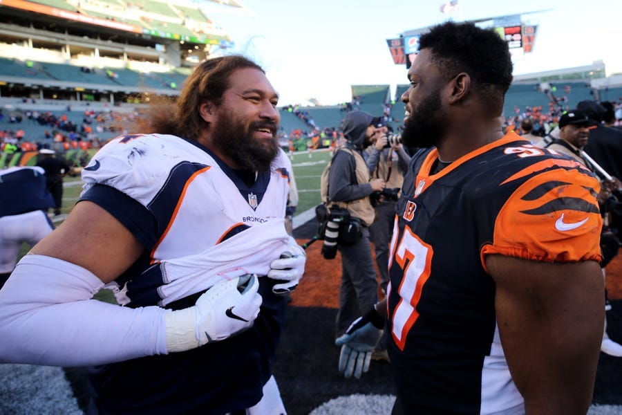 Denver Broncos nose tackle Domata Peko (94) and Cincinnati Bengals defensive tackle Geno Atkins (97) talk after a Week 13 NFL football game, Sunday, Dec. 2, 2018, at Paul Brown Stadium in Cincinnati. The Denver Broncos won and the Cincinnati Bengals fell to 5-7 on the season with the loss. 