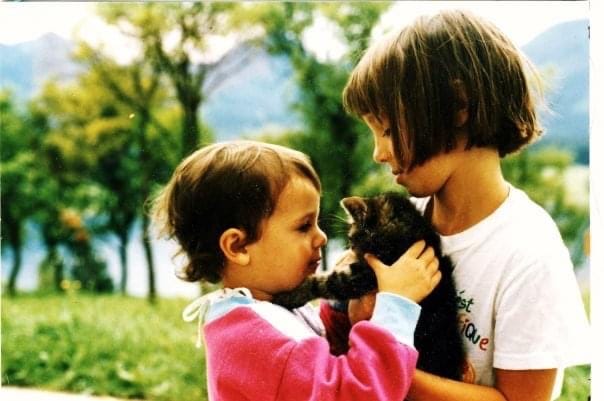 liz as baby with her sister holding cat