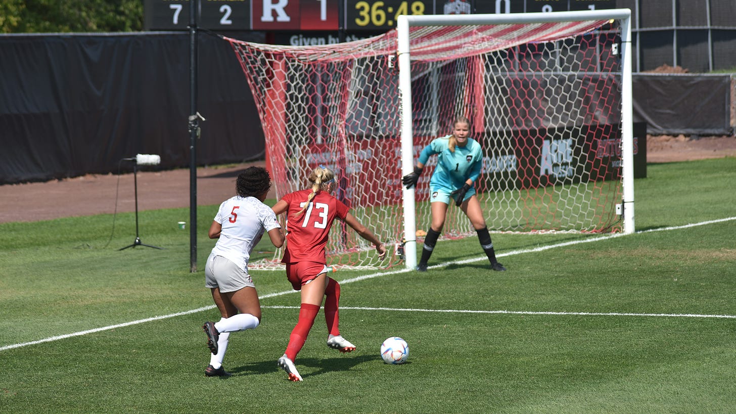 Rutgers soccer player dribbles against Ohio State player