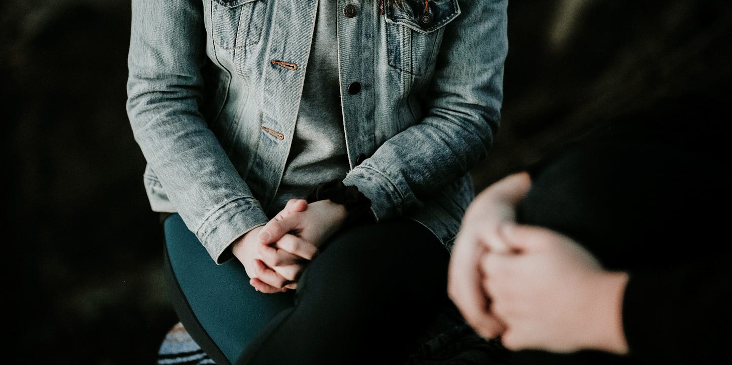 A header image of two people in a therapy session.