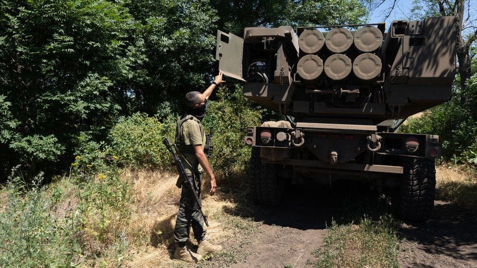 A Ukrainian soldier inspect a HIMARS artillery system