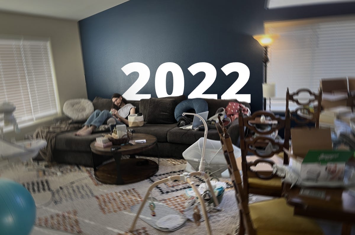 Rick sits on a couch in a messy living room. A big "2022" is overlaid as if popping up from behind the couch. The image is blurred and chaotic from all the mess.