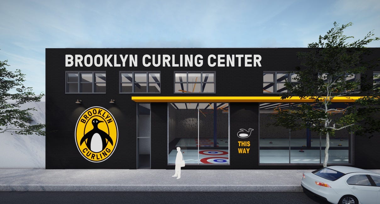 A rendering of the Brooklyn Curling Center. A large, warehouse type building, with a cute penguin logo and large windows showing the ice sheets. A rendering of the Brooklyn Curling Center. A large, warehouse type building, with a cute penguin logo and large windows showing the ice sheets.