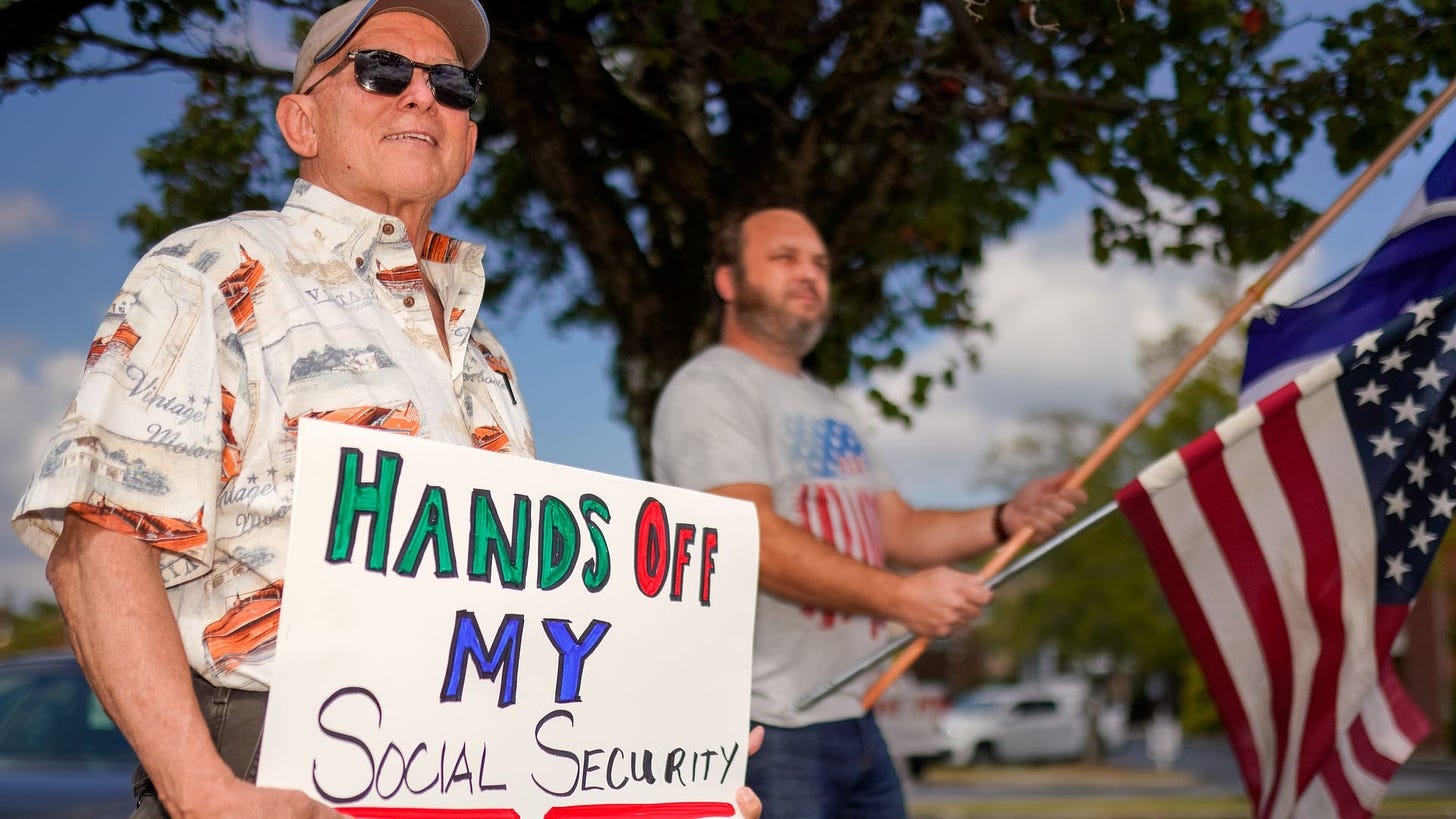 A demonstrator holding a sign that says: Hands off my Social Security