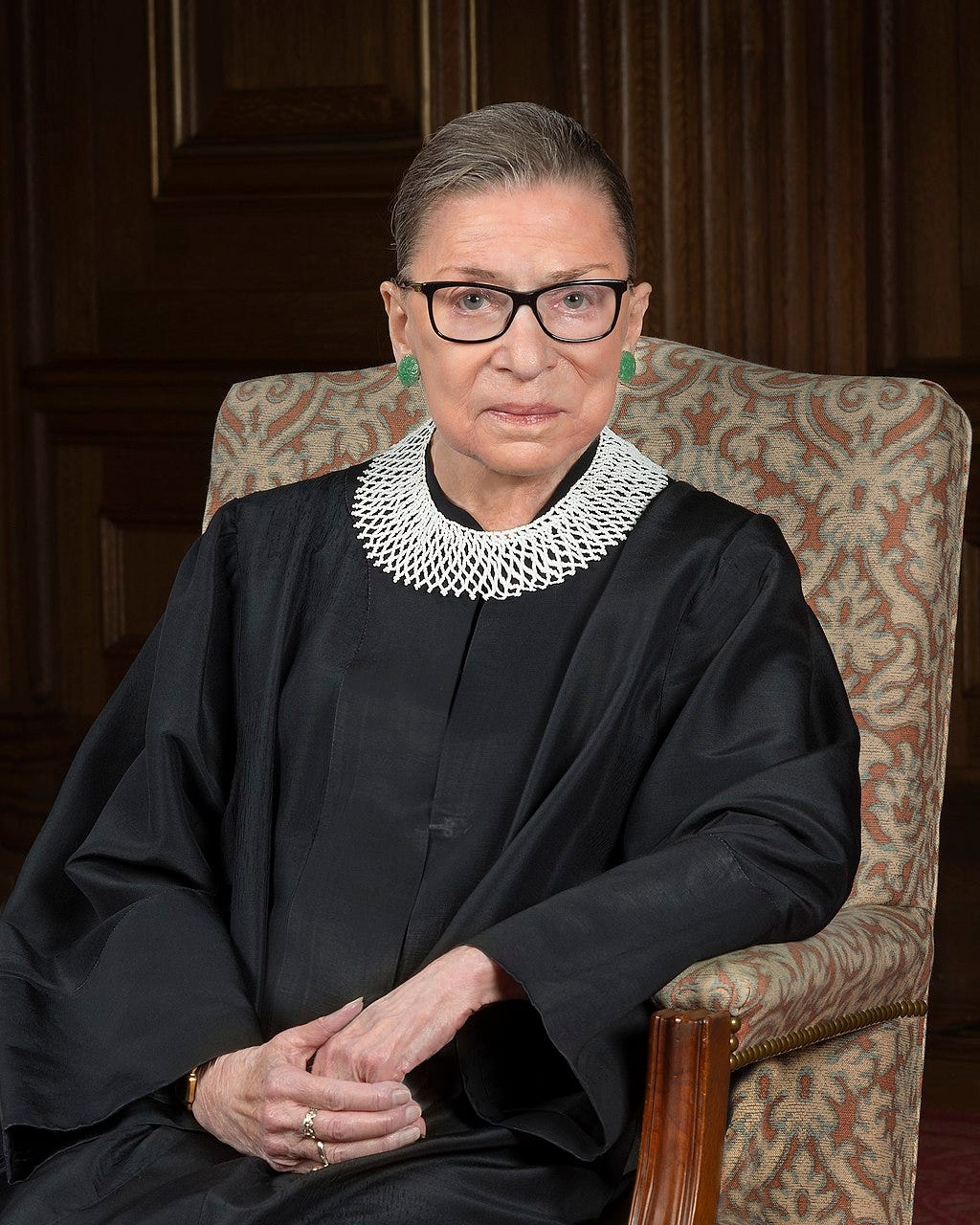 Ginsburg seated in her robe