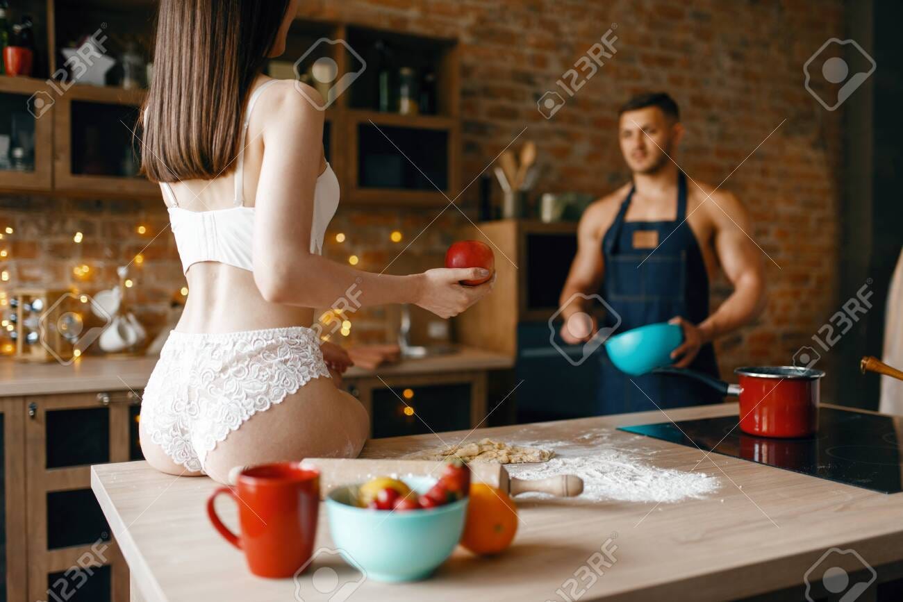 Sexy Couple In Underwear Cooking On The Kitchen Stock Photo, Picture And  Royalty Free Image. Image 129966354.