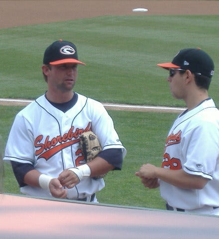 Wally Crancer (left) talks to pitcher John Mariotti before a game.