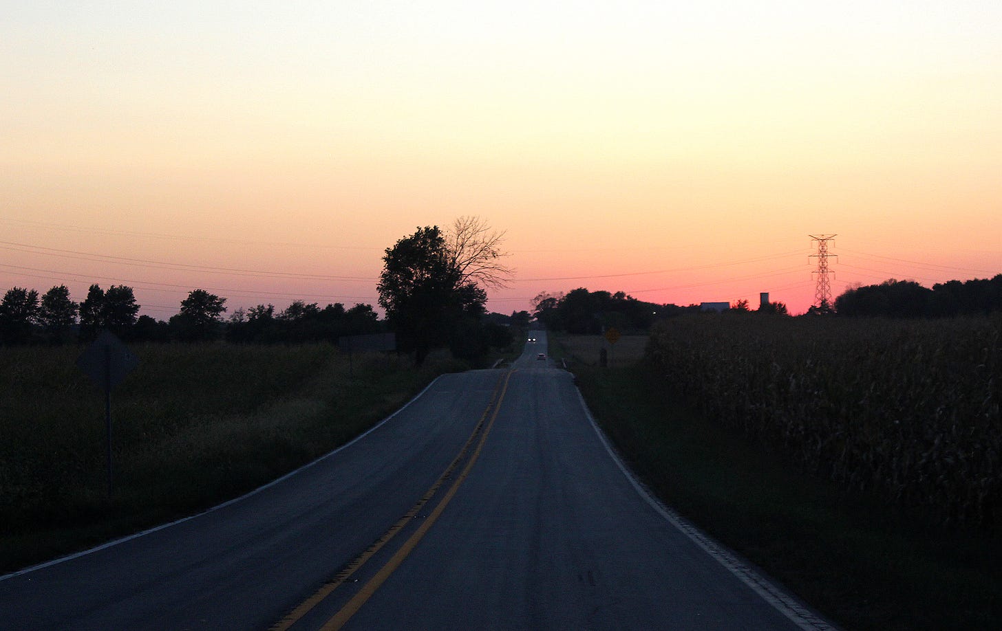 Corn on the right, beans on the left. Roads like this are obligatory travel corridors in this state. Yet, we regard them as things of beauty, particularly on nights with cloudless sunsets.