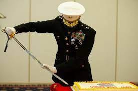 Cutting the cake whith his sword — an officer yyet!