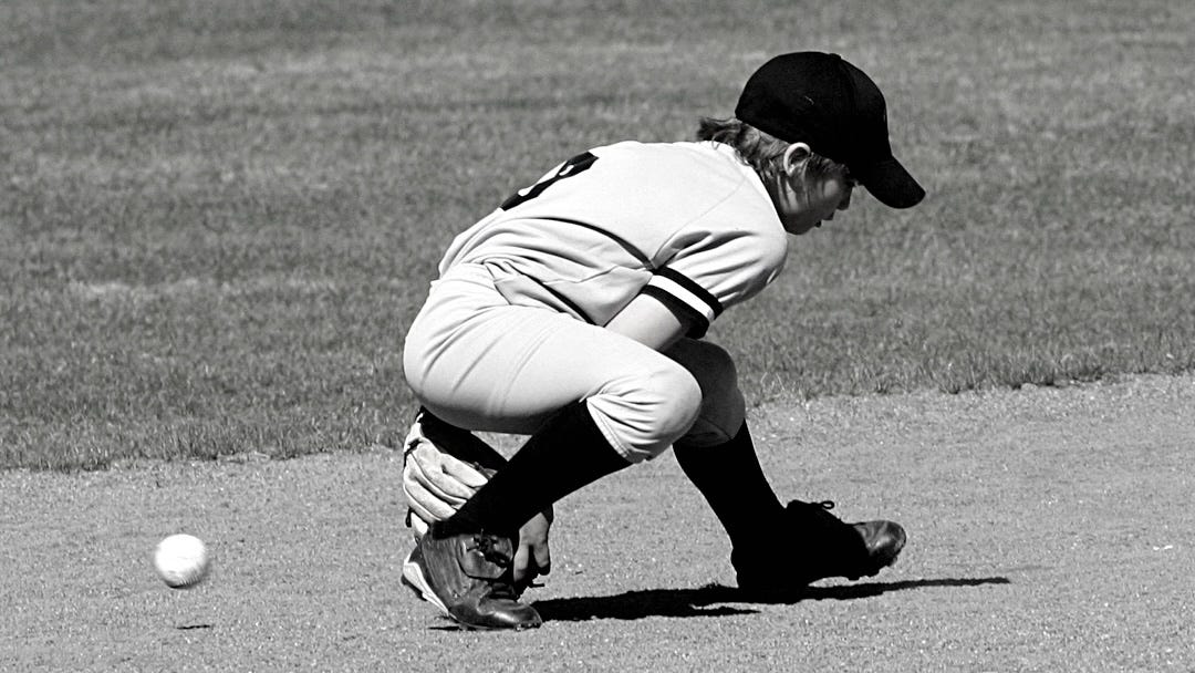boy committing baseball error