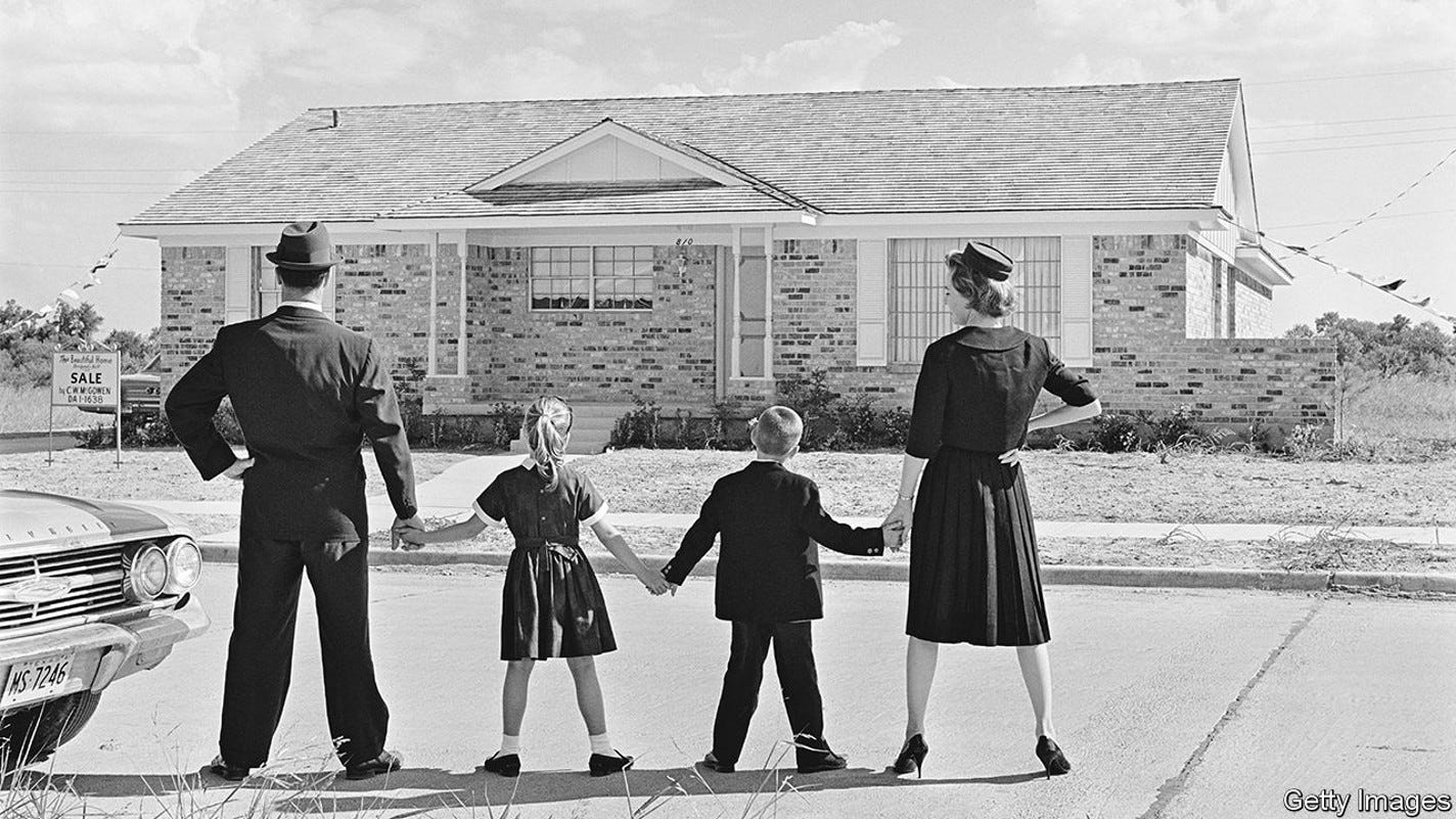 1960S FAMILY OF FOUR SEEN FROM BEHIND STANDING IN FRONT OF NEW SUBURBAN HOUSE HOLDING HANDS (Photo by Camerique/ClassicStock/Getty Images)