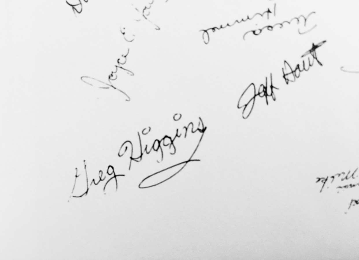 A page from a high school yearbook with senior signatures. Greg Higgins is there with dots on the i’s and a long loop extending downward from the S like a tail.