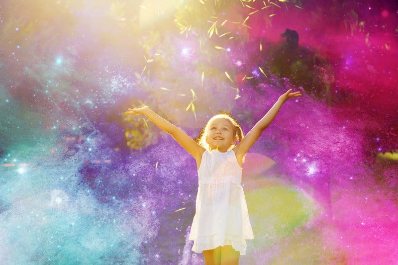 Small child dancing in different colours of light