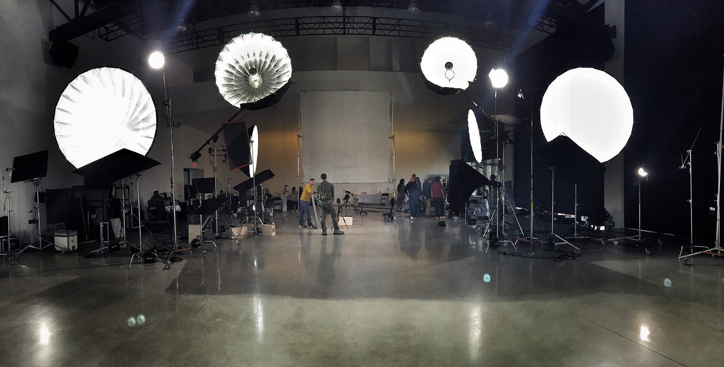 Behind the scenes production photo with 4 large parabolic umbrellas