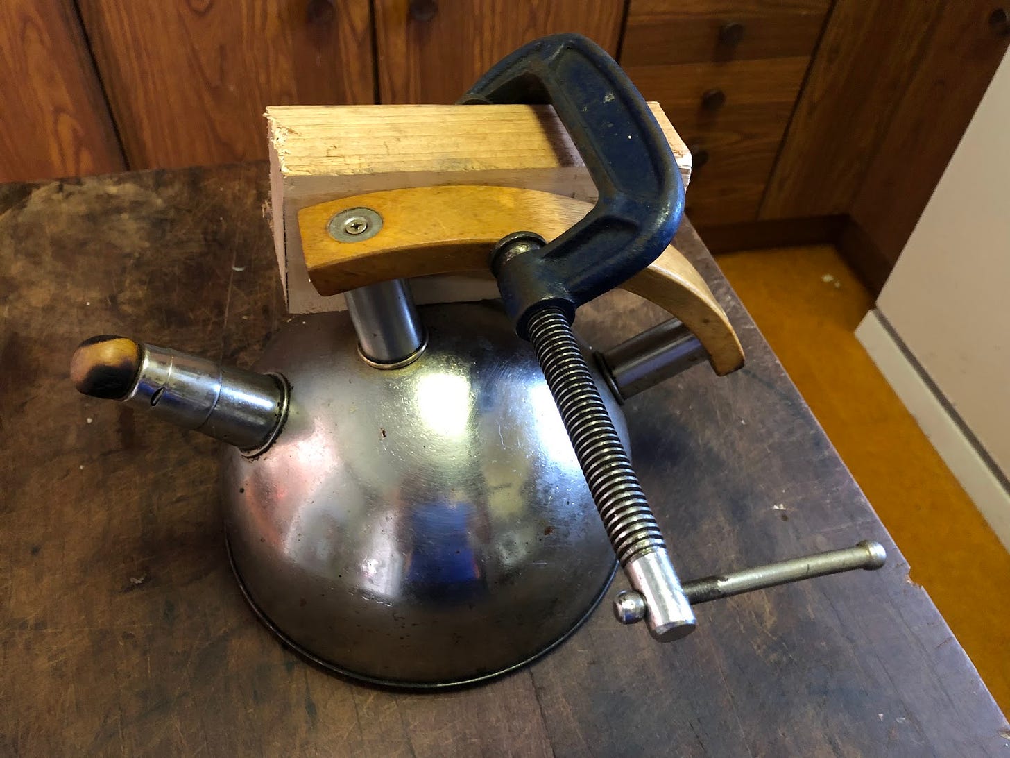 Kettle with clamp and timber