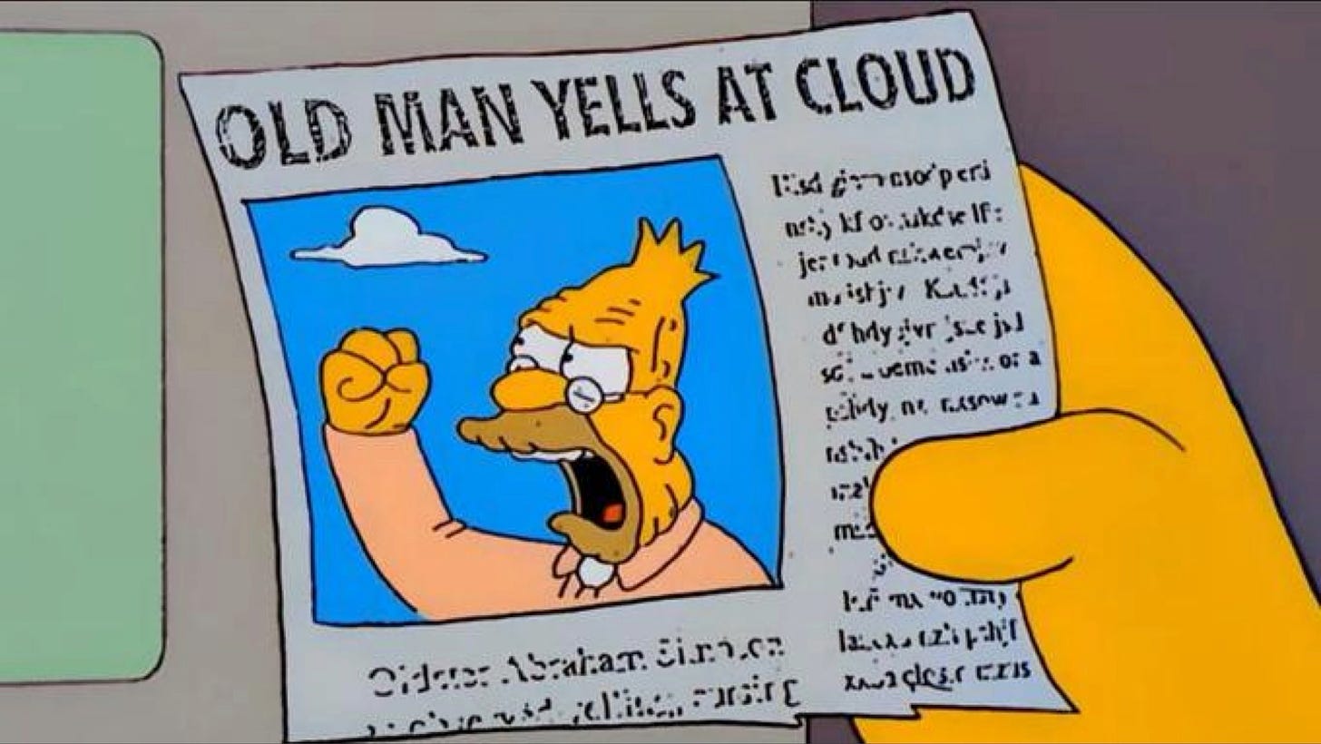 Frame from the TV show THE SIMPSONS, showing a hand holding a newspaper clipping with the title OLD MAN YELLS AT CLOUD, and a picture of an old man seemingly yelling at a cloud above him