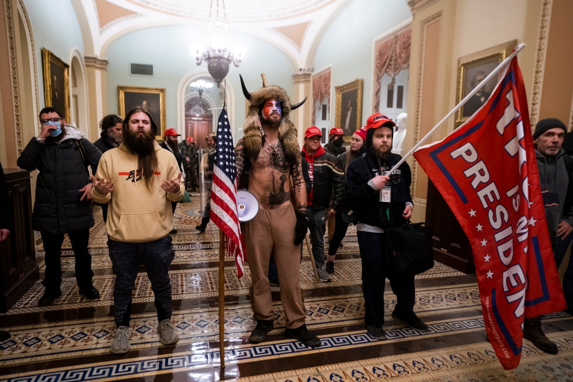 Supporters of US President Donald Trump stand by the door to the Senate chambers after they breached the US Capitol security in Washington [EFE/JIM LO SCALZO]