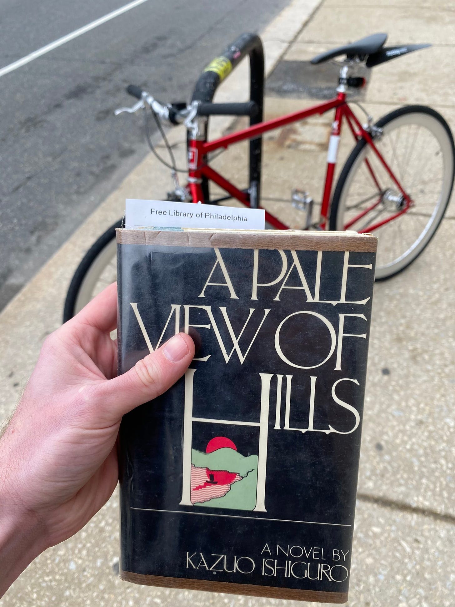 bike and a pale view of hills book