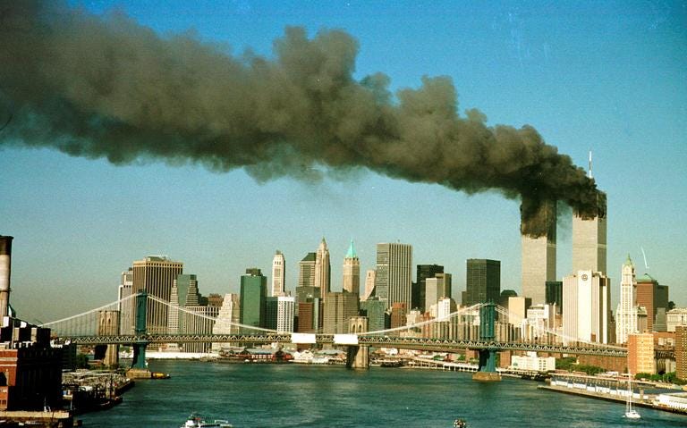 Smoke is seen at the towers of the World Trade Center shortly after being struck by a hijacked commercial aircraft, in New York, U.S., September 11, 2001. REUTERS/Brad Rickerby/File Photo