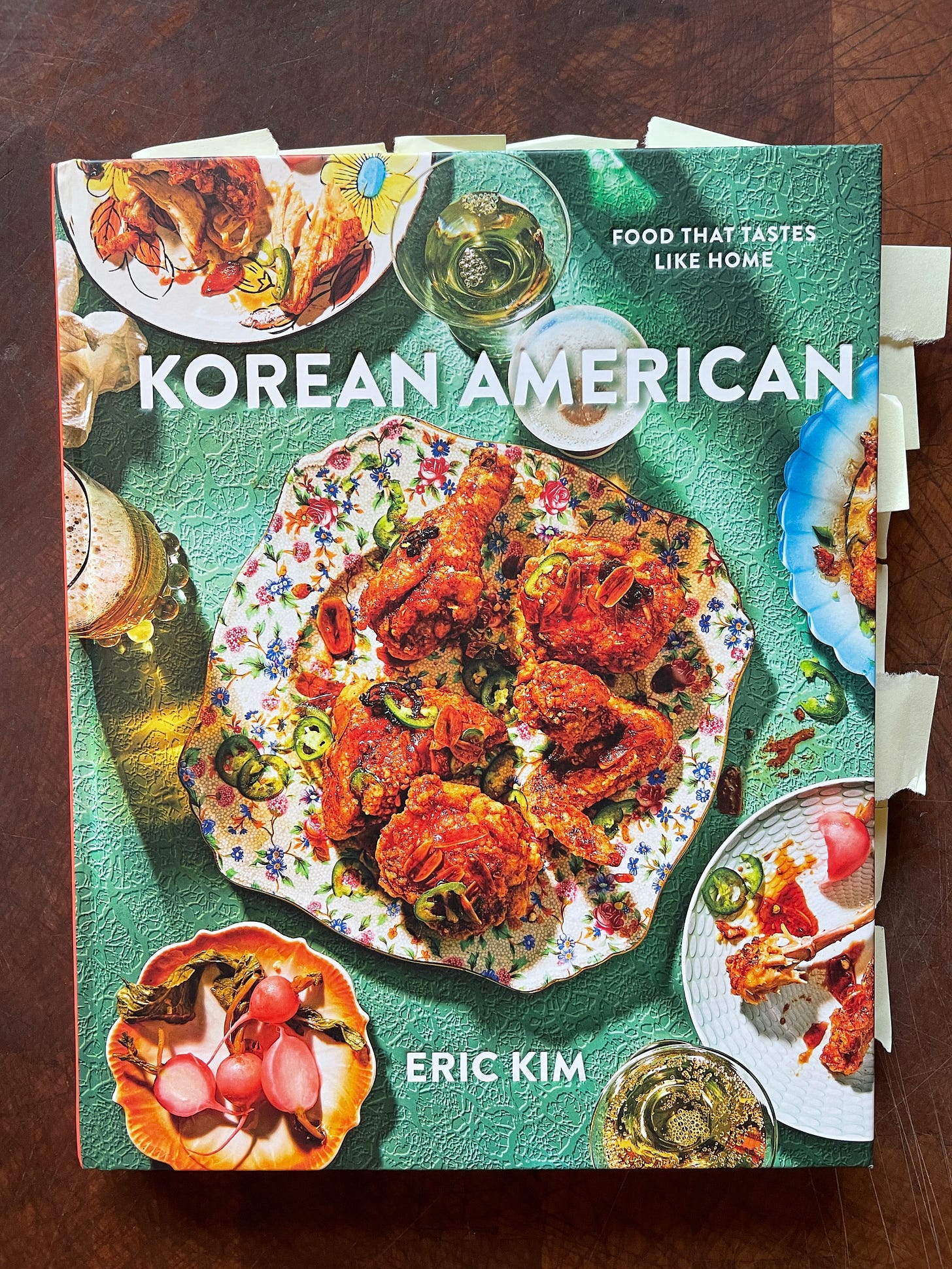 Image of a cookbook with text "Korean American: Food That Tastes Like Home" and a photo of fried chicken on the cover